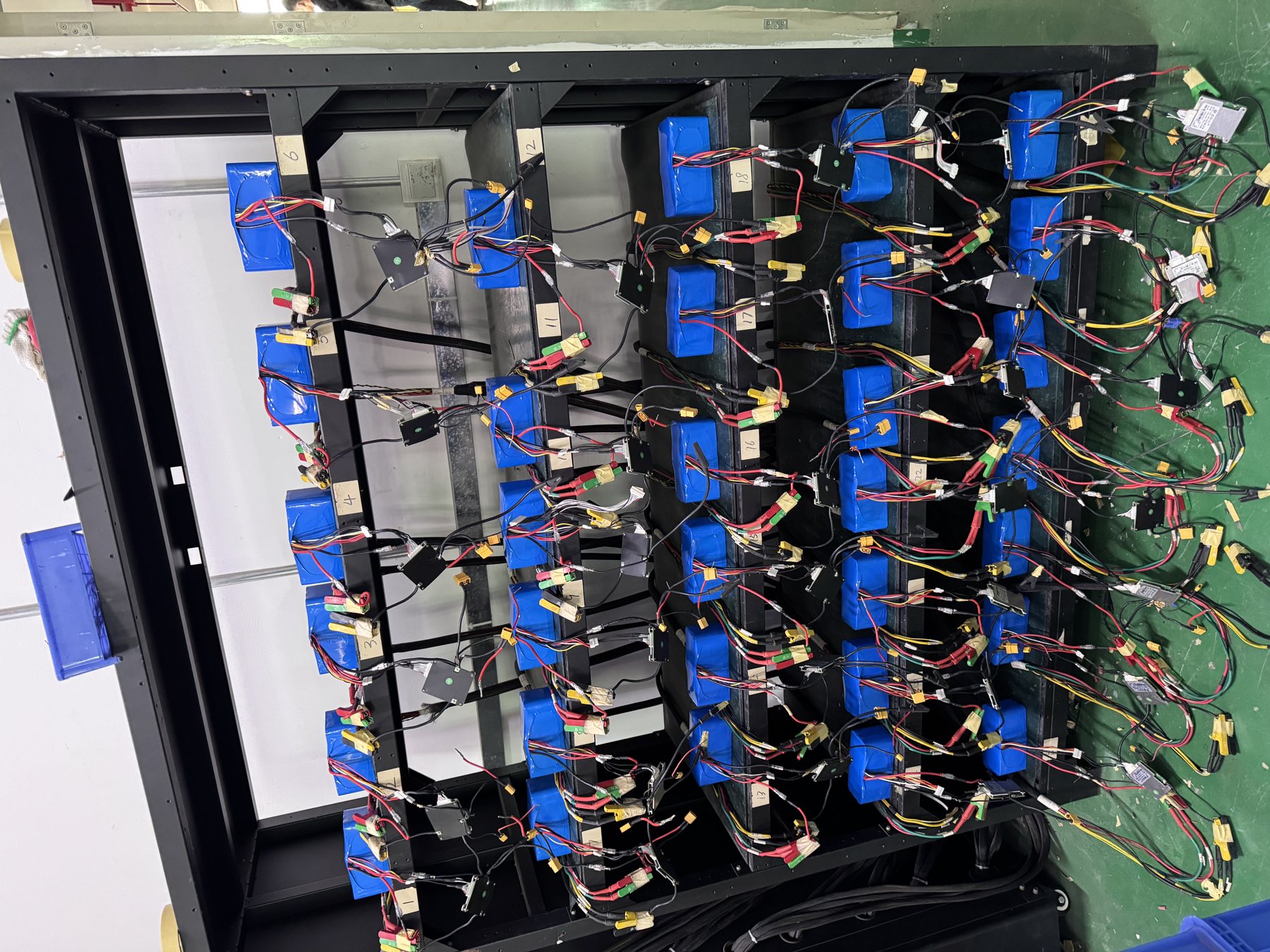 Open battery pack showing modules and wiring during assembly